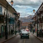 A bustling street scene in historic Cusco, Peru, featuring colonial architecture.